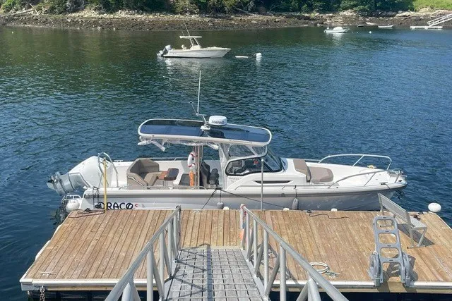 The Image of 2025 Nimbus Tender 9 docked on a serene lake with surrounding boats. - 0