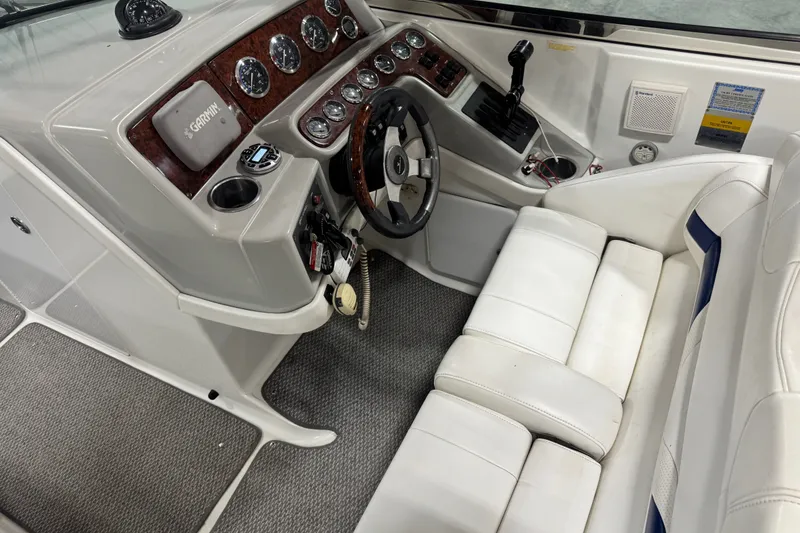 Slide: The Image of 2005 Formula 280 Bowrider cockpit with white seating, steering wheel, and control panel. - 17