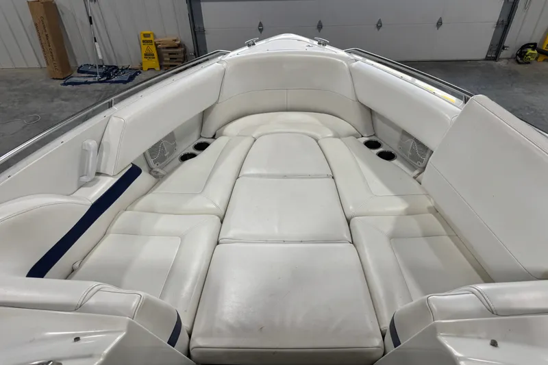 Slide: The Image of 2005 Formula 280 Bowrider interior with white cushioned seating in a garage setting. - 16