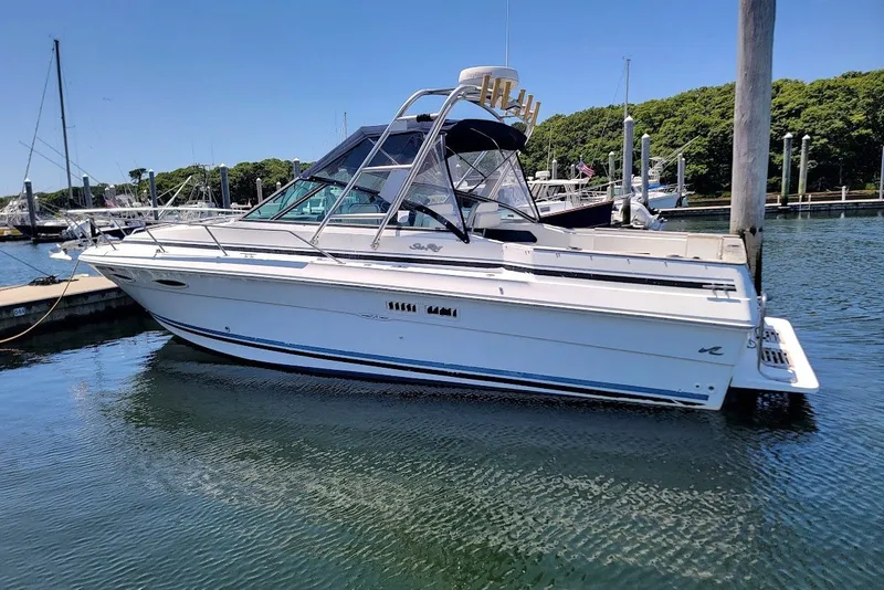 Slide: The Image of 1989 Sea Ray 270 Amberjack boat docked in a marina on a sunny day. - 14