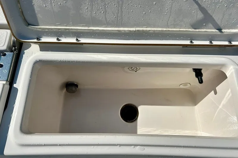 Slide: The Image of Open storage compartment on 2022 BLUEWAVE 2000 Classic boat, showing interior details. - 22