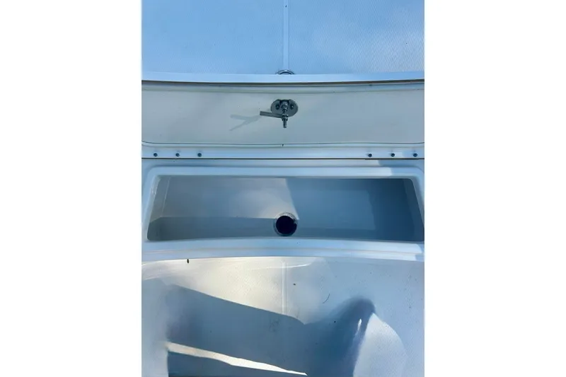 Slide: The Image of 2022 BLUEWAVE 2000 Classic boat storage compartment with open lid and drain. - 17