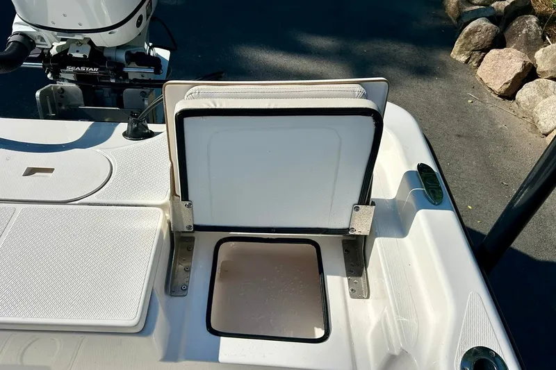 Slide: The Image of Open storage compartment on a 2022 BLUEWAVE 2000 Classic boat, featuring a Seastar engine. - 9