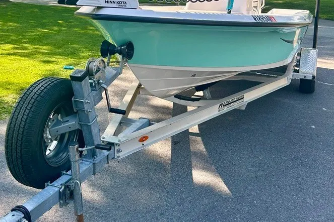 Slide: The Image of 2022 BLUEWAVE 2000 Classic boat on trailer, parked on a sunny driveway. - 6