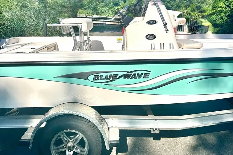 The Image of 2022 BLUEWAVE 2000 Classic boat on trailer, featuring sleek design and vibrant graphics. - 0