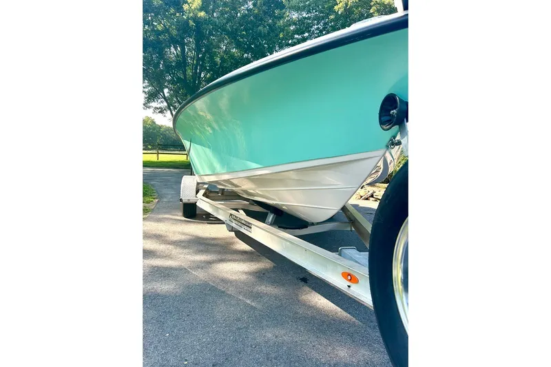 Slide: The Image of 2022 BLUEWAVE 2000 Classic boat on trailer, parked on a sunny driveway. - 5