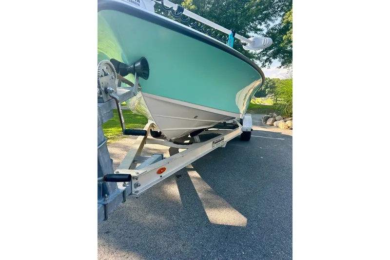 Slide: The Image of 2022 BLUEWAVE 2000 Classic boat on trailer, parked on a sunny driveway. - 4