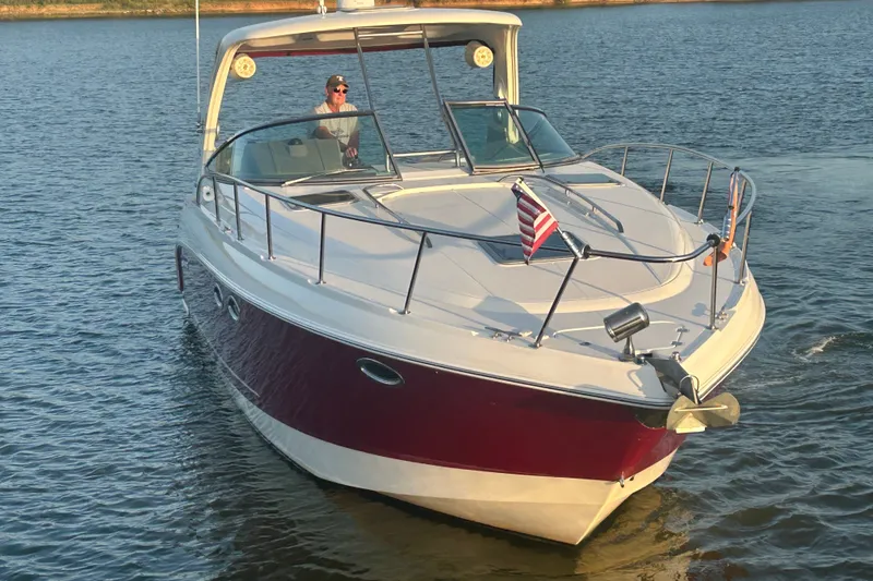 Slide: The Image of 2010 Chaparral Signature 370 boat cruising on a calm lake. - 9