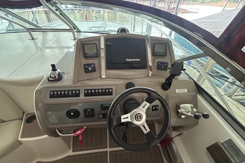 Slide: The Image of Cockpit of 2010 Chaparral Signature 370 with steering wheel and Raymarine navigation system. - 21