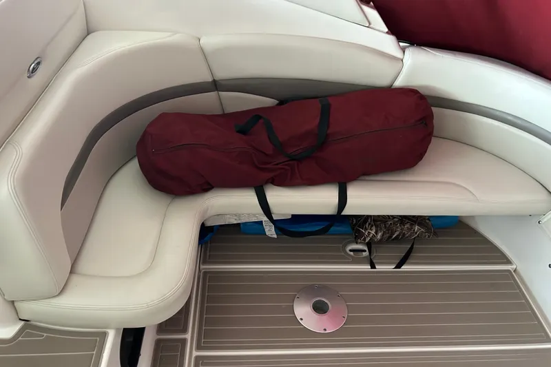 Slide: The Image of Chaparral Signature 370 boat interior with beige seating and a maroon bag, 2010 model. - 19