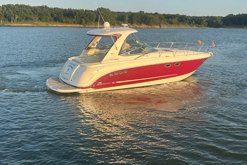 Slide: The Image of Chaparral Signature 370 boat, 2010 model, cruising on a serene lake at sunset. - 12