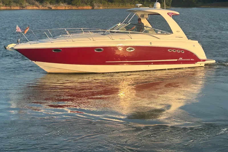 Slide: The Image of 2010 Chaparral Signature 370 boat cruising on a calm lake at sunset. - 16