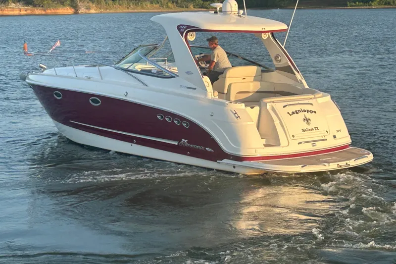 Slide: The Image of Chaparral Signature 370 boat from 2010 cruising on a calm lake. - 15
