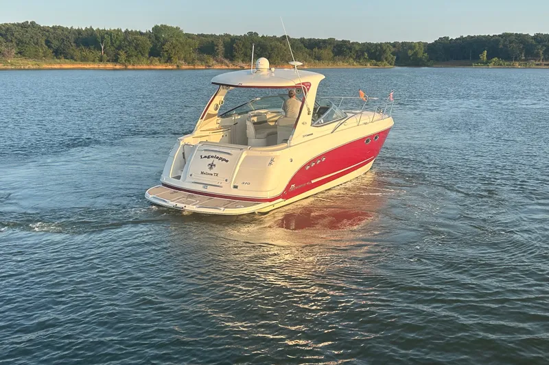Slide: The Image of 2010 Chaparral Signature 370 boat cruising on a serene lake. - 13