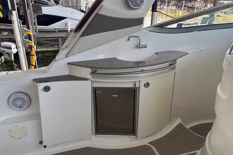 Slide: The Image of 2010 Chaparral Signature 370 boat kitchenette with sink and storage. - 26