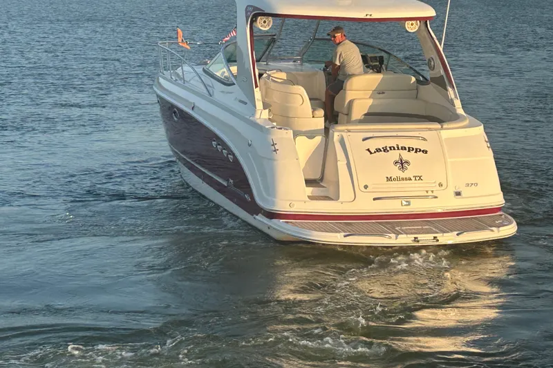 Slide: The Image of Chaparral Signature 370 boat cruising on water, 2010 model, with a person onboard. - 14