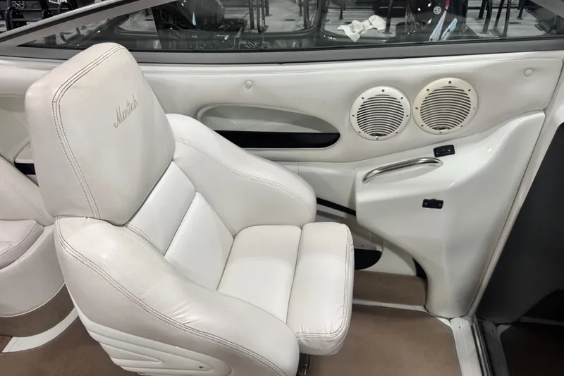 Slide: The Image of Interior of a 2000 Mariah 302 Shabah boat with white seating and speakers. - 8