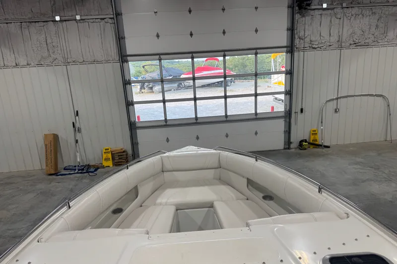 Slide: The Image of 2000 Mariah 302 Shabah boat interior in a garage with a view outside. - 9