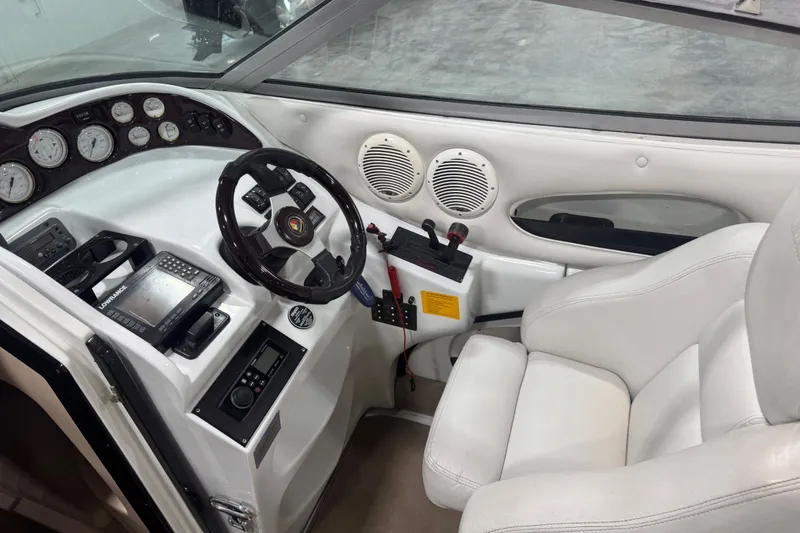 Slide: The Image of Cockpit of 2000 Mariah 302 Shabah boat with steering wheel and navigation instruments. - 7