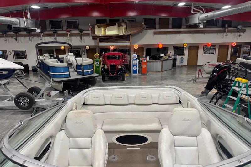 Slide: The Image of Interior view of a 2000 Mariah 302 Shabah boat in a showroom with vintage decor. - 13