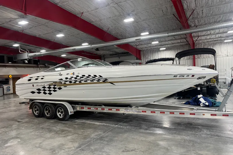 The Image of 2000 Mariah 302 Shabah boat on trailer in indoor showroom. - 1