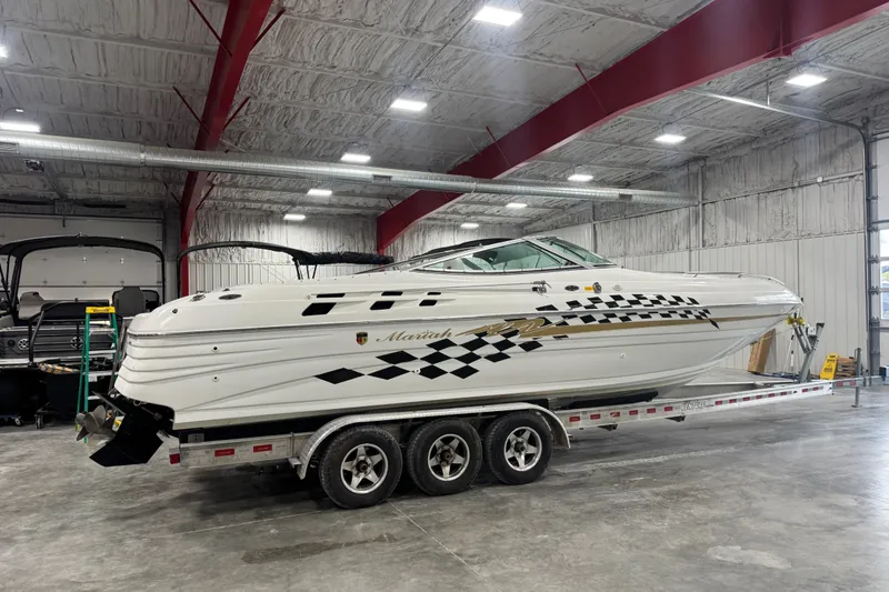 Slide: The Image of 2000 Mariah 302 Shabah boat on trailer in indoor storage facility. - 3