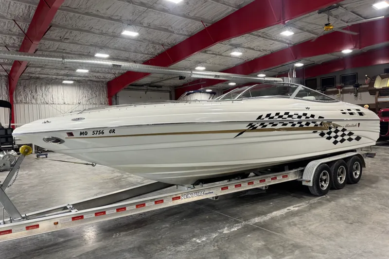 Slide: The Image of 2000 Mariah 302 Shabah boat on trailer in indoor storage facility. - 2