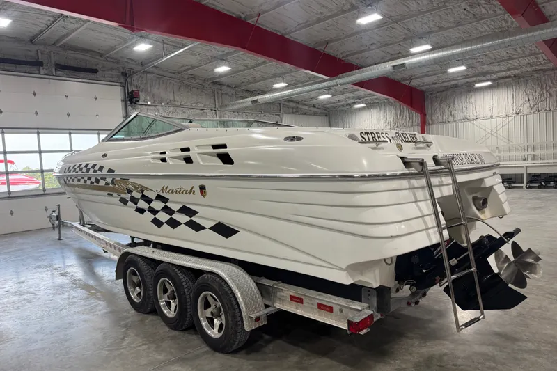 Slide: The Image of 2000 Mariah 302 Shabah boat on trailer in indoor storage facility. - 4