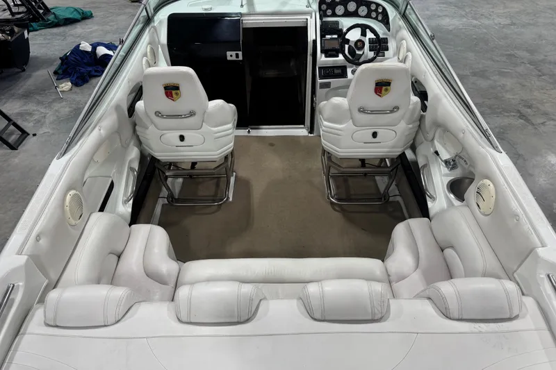 Slide: The Image of Interior of a 2000 Mariah 302 Shabah boat with white seating and dashboard. - 5