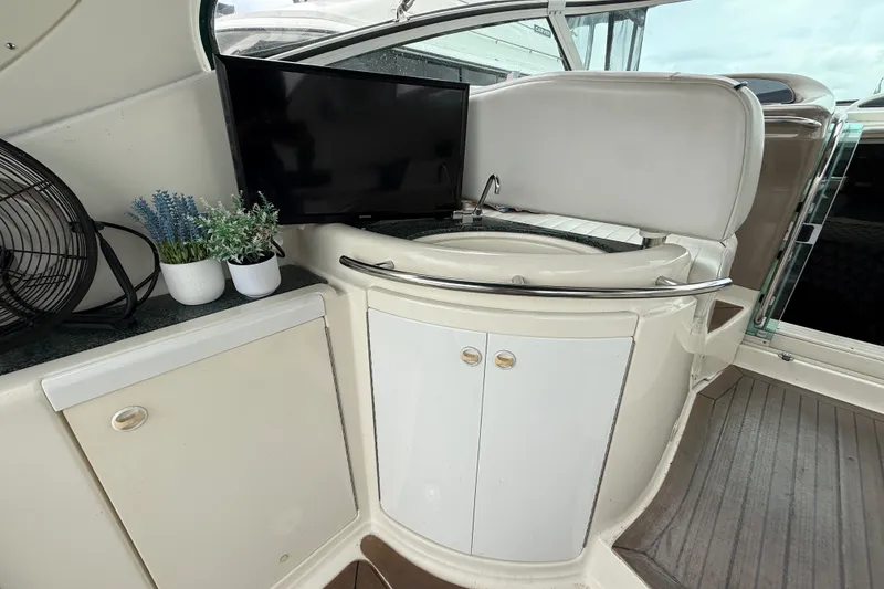 Slide: The Image of 2003 Maxum 3700 SCR yacht interior with TV, sink, and potted plants. - 13