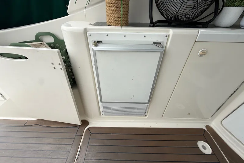 Slide: The Image of 2003 Maxum 3700 SCR boat interior with storage compartments and wooden flooring. - 15