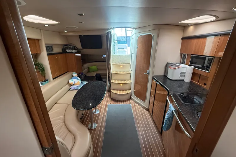 Slide: The Image of Luxurious interior of 2003 Maxum 3700 SCR yacht with modern kitchen and cozy seating area. - 43