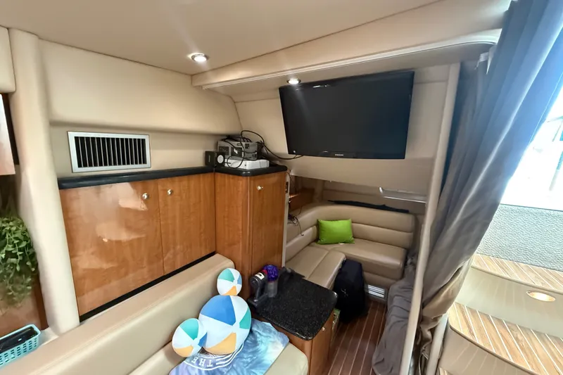 Slide: The Image of Interior of 2003 Maxum 3700 SCR yacht with seating, TV, and wooden cabinetry. - 44