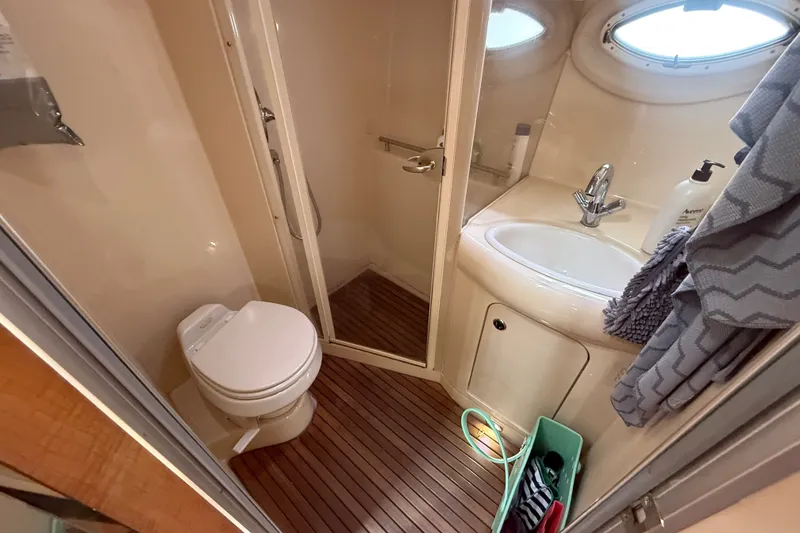 Slide: The Image of 2003 Maxum 3700 SCR yacht bathroom with toilet, sink, and shower. - 51
