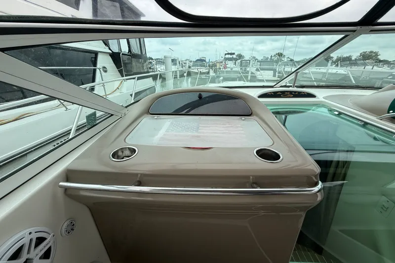 Slide: The Image of 2003 Maxum 3700 SCR boat interior with dashboard and marina view. - 18