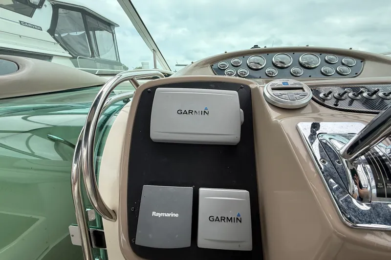 Slide: The Image of Dashboard of a 2003 Maxum 3700 SCR boat featuring Garmin and Raymarine equipment. - 27
