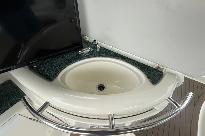 Slide: The Image of 2003 Maxum 3700 SCR yacht sink with countertop and TV nearby. - 14