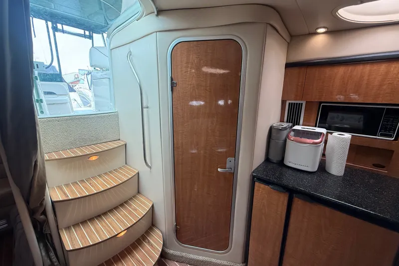 Slide: The Image of Interior of 2003 Maxum 3700 SCR yacht with wooden stairs and kitchenette. - 35