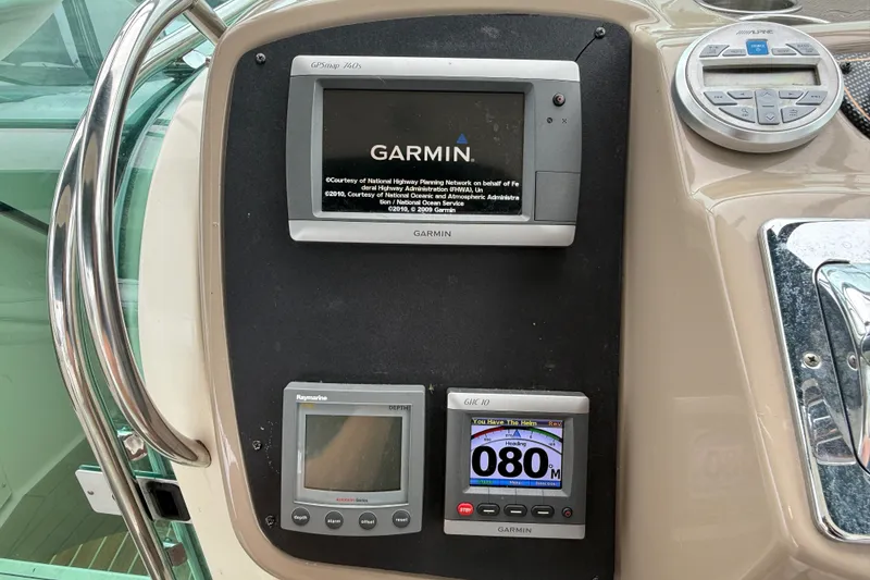 Slide: The Image of Dashboard of a 2003 Maxum 3700 SCR boat featuring Garmin and Raymarine navigation systems. - 29