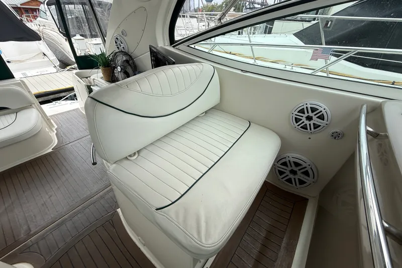 Slide: The Image of 2003 Maxum 3700 SCR boat interior with white seating and speakers. - 19