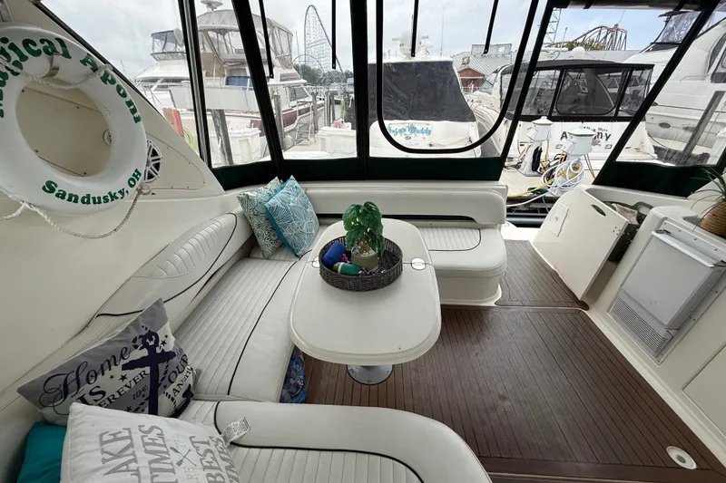 Slide: The Image of Interior of 2003 Maxum 3700 SCR yacht with cozy seating and decorative pillows. - 21