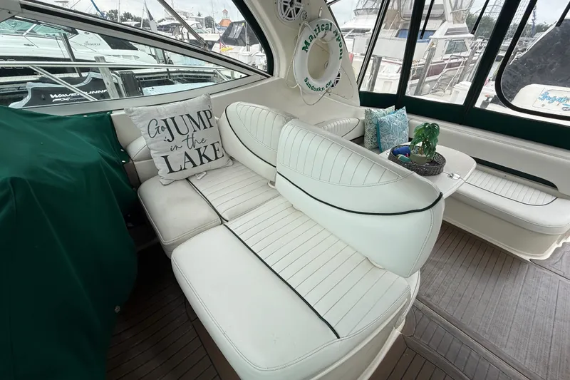Slide: The Image of 2003 Maxum 3700 SCR yacht interior with white seating and decorative pillows. - 22