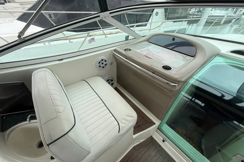 Slide: The Image of 2003 Maxum 3700 SCR boat interior with white seating and dashboard view. - 17