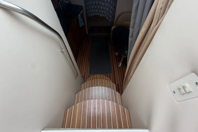 Slide: The Image of Interior stairs of 2003 Maxum 3700 SCR yacht with wooden flooring and handrail. - 30