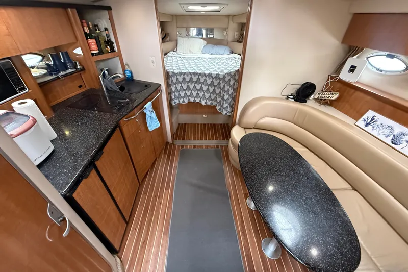 Slide: The Image of Interior of 2003 Maxum 3700 SCR yacht with kitchen, seating, and sleeping area. - 31