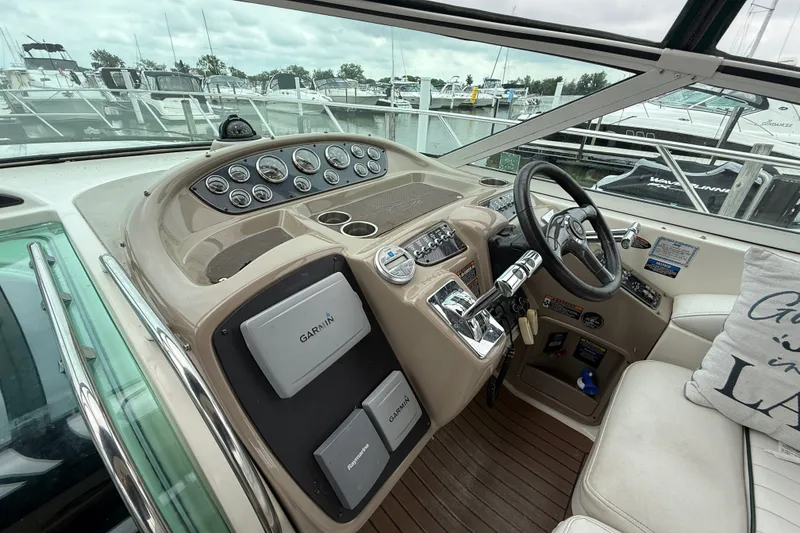 Slide: The Image of 2003 Maxum 3700 SCR boat cockpit with Garmin navigation system and steering wheel. - 24