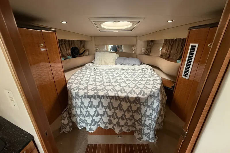 Slide: The Image of Cozy cabin interior of 2003 Maxum 3700 SCR yacht with bed and wooden cabinets. - 40