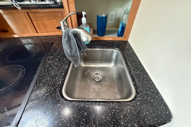 Slide: The Image of Kitchen sink and countertop in 2003 Maxum 3700 SCR boat interior. - 39