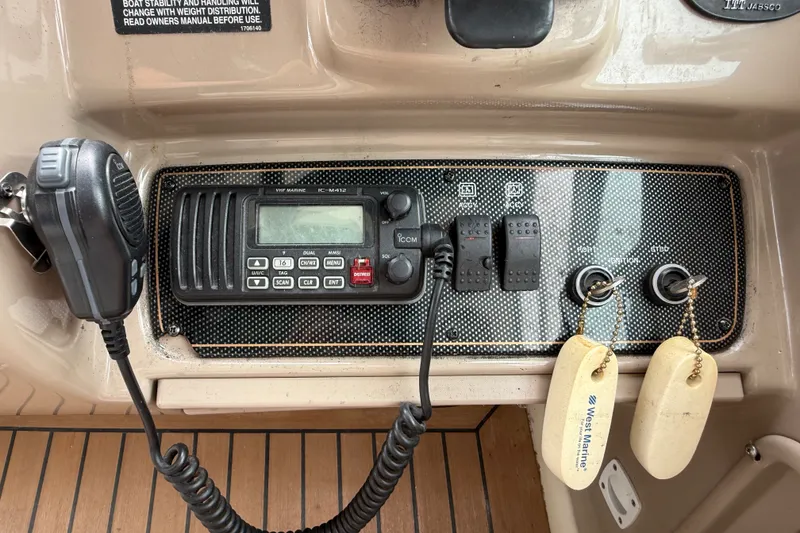 Slide: The Image of Control panel of a 2003 Maxum 3700 SCR boat with VHF marine radio and ignition keys. - 28
