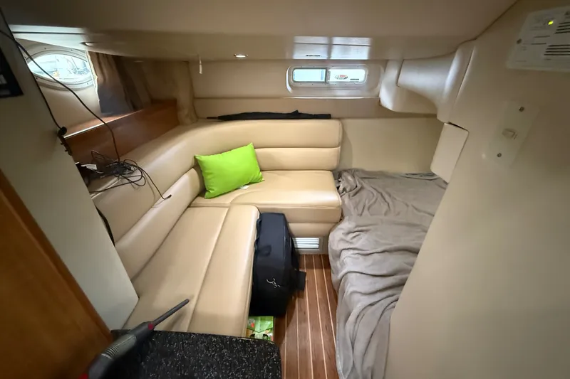 Slide: The Image of Cozy interior of 2003 Maxum 3700 SCR yacht with beige seating and green pillow. - 46